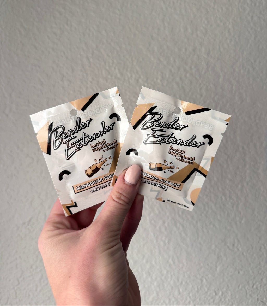Hand holding multiple packets of Bender Extender Hangover Support